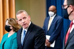 FBI Deputy Director Paul Abbate, second from left, speaks during a news conference at the Department of Justice in Washington, Oct. 26, 2021.