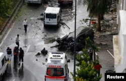 A destroyed van is pictured near a Turkish police bus which was targeted in a bomb attack in a central Istanbul district, Turkey, June 7, 2016.