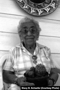 Amada Cardenas holds a pot of peyote while sitting on her front porch in Mirando City Texas, 1994. Photo published in "Amada's Blessings From the Peyote Gardens of South Texas," University of New Mexico Press, 2015. Photo Courtesy of Stacy B. Schaefer.