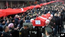 FILE - People carry the coffin after funeral prayers for Turkish soldier Goktan Ozupekin, who was killed with 15 others by IS militants in al-Bab, Syria, in Kirklareli , Turkey, Dec. 23, 2016.