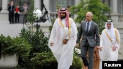 FILE - Saudi Arabia's Deputy Crown Prince and Minister of Defense Mohammed Bin Salman (L) arrives at the Oval Office of the White House for a meeting with U.S. President Barack Obama in Washington, June 17, 2016