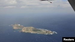 FILE - Photograph taken on a marine surveillance plane B-3837 shows the disputed islets, known as Senkaku in Japan and Diaoyu in China.