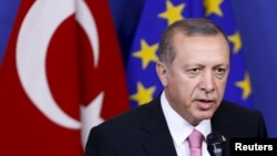FILE - Turkey's President Tayyip Erdogan talks to the media at the EU Commission headquarters in Brussels, Belgium, Oct. 5, 2015. 