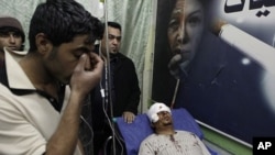 Mohammed Ali lies in a hospital bed after being injured in a car bomb attack in Zafaraniyah, Baghdad, Iraq, Jan. 27, 2012.