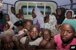 FILE - Women and children rescued by Nigeria soldiers from Islamist extremists at Sambisa forest arrive at a camp in Yola, Nigeria, May 2, 2015.