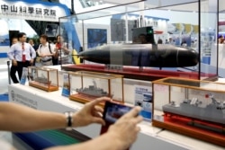 2016年9月16日台湾高雄的国际海事与防卫工业展会上人们聚集在台湾China Shipbuilding Corporation （CSBC) 展亭前观看台湾首艘国造潜艇模型。 (路透社照）