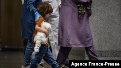 Afghan evacuees arrive at Incheon International Airport in Incheon, South Korea, Aug. 26, 2021, after fleeing from their country following the Taliban's military takeover of Afghanistan. 