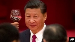 FILE - Chinese President Xi Jinping toasts during a reception at the Great Hall of the People on the eve of the Oct. 1 National Day holiday in Beijing.