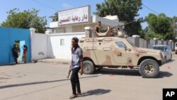 FILE - Yemeni security forces gather outside an elderly care home after it was attacked by gunmen in the port city of Aden, Yemen. Negotiations are being held in Kuwait and were due to start on Monday.