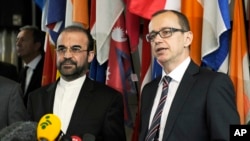 Iran's Ambassador to the International Atomic Energy Agency, IAEA, Reza Najafi (l) and IAEA Deputy Director General and Head of the Department of Safeguards Tero Tapio Varjoranta, right, deliver a statement after their meeting at the International Center 