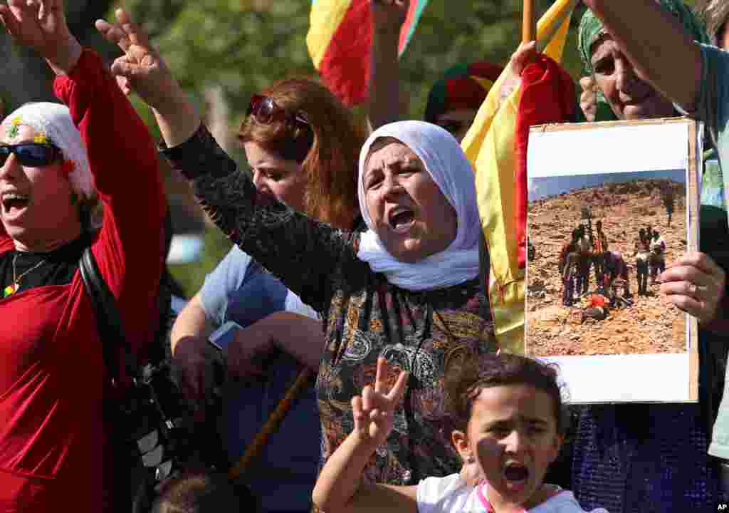 Kurdish citizens who live in Lebanon shout slogans during a demonstration against militants who refer to themselves as the Islamic State, in front of the UN building, in downtown Beirut, Lebanon, Sept. 15, 2014.