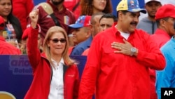 Venezuela's President Nicolas Maduro and first lady Cilia Flores acknowledge supporters at the end of a rally in Caracas, Venezuela, Feb. 2, 2019.