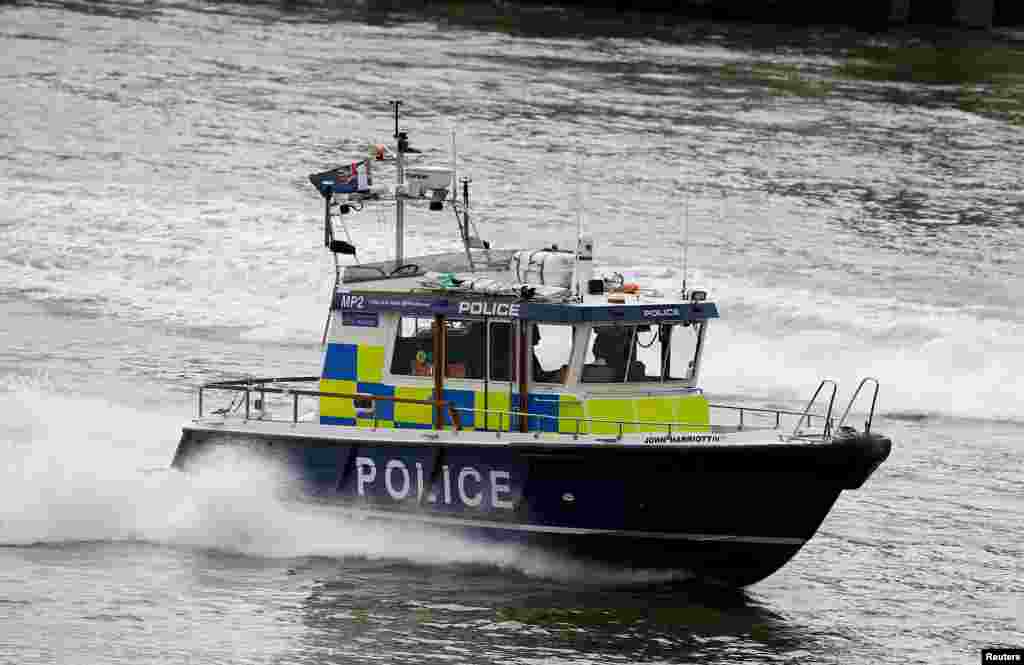 Police patrol along the Thames near London Bridge after it was reopened, June 5, 2017.