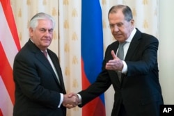 FILE - U.S. Secretary of State Rex Tillerson and Russian Foreign Minister Sergey Lavrov shake hands prior to their talks in Moscow, Russia, April 12, 2017.
