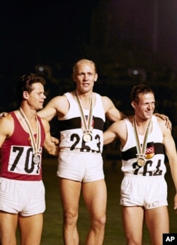 he top three finishers in the Olympic decathlon Summer Games at Tokyo, Oct. 20, 1964 stand on the winner's podium with their medals. From left are: Rein Aun, USSR; second place; Willi Holdorf, winner, Germany; and Hans-Joachim Walde, Germany, third. (AP