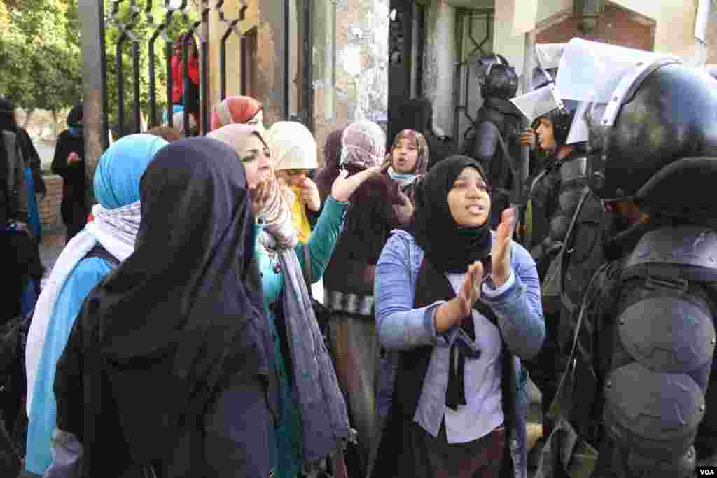 Female Islamist students speak to police during a protest at Al-Azhar University in Cairo, Dec. 11, 2013. (Hamada Elrasam for VOA)