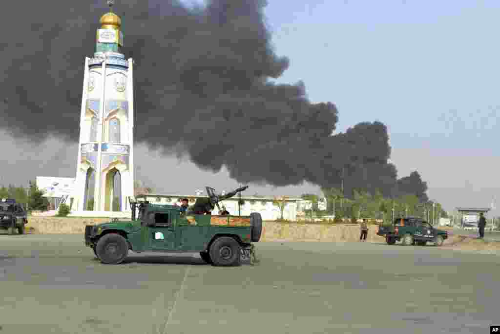 Afghan security forces arrive after a powerful explosion outside the provincial police headquarters in Kandahar province south of Kabul.