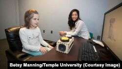 Temple University graduate student Zoe Ngo tests a young student for school's memory study.