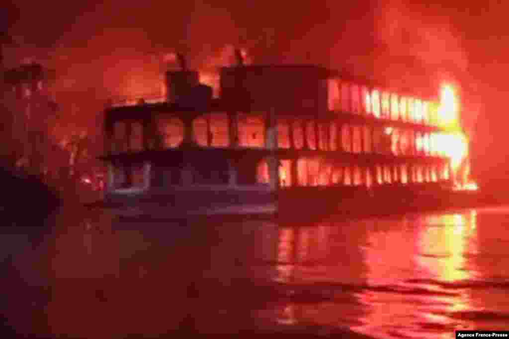 This frame grab from an AFPTV video shows a burning ferry after it caught on fire killing at least 37 people in Jhalkathi, 250 kilometers (160 miles) south of Dhaka, early on Dec. 24, 2021.