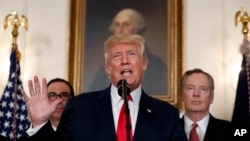 President Donald Trump speaks during an event to sign a memorandum calling for a trade investigation of China, Aug. 14, 2017, in the White House. U.S. Trade Representative Robert Lighthizer is behind him to the right.