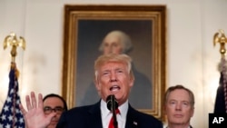 President Donald Trump speaks during an event to sign a memorandum calling for a trade investigation of China, Aug. 14, 2017, in the White House. U.S. Trade Representative Robert Lighthizer is behind him to the right.
