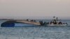 Des enquêteurs en plein travail sur le ferry chaviré MV Nyerere avec un bilan de plus de 150 morts dans le lac Victoria, en Tanzanie, le 21 septembre 2018.