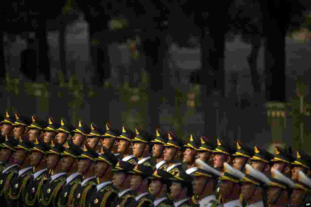 Members of the honor guard stand at attention during a welcoming ceremony for visiting Mozambique&#39;s President Filipe Jacinto Nyusi at the Great Hall of the People in Beijing, China.