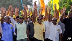 Former President of the Maldives Mohamed Nasheed displays his candidate number with his fingers during a campaign rally ahead of the presidential runoff in Male, Nov. 15, 2013. 