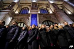 Romanian magistrates stand during a silent protest outside the Bucharest Court of Appeal in Bucharest, Romania, Dec. 18, 2017.