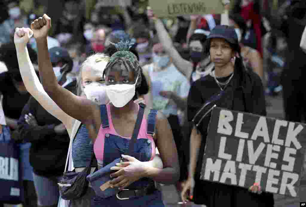 Young women take part in a Black Lives Matter anti-racism protest rally in Berlin, Germany, June 27, 2020.