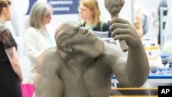 FILE - A 3D-printed model of a Neanderthal man stands at the stand of FIT AG during a media presentation at the international fairs FabCon 3.D and Rapid.Tech, Germany, June 5, 2018. 