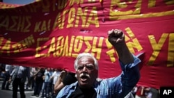 A protester shouts slogans during a May Day protest in Athens, May 1, 2012.