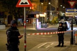 Police officers secure an area after exchanges of gunfire in Vienna, Austria, Nov. 3, 2020.