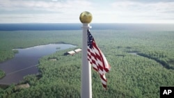 FILE - This image from video provided by the Flagpole of Freedom Park in 2022 shows a rendering of a proposed world's tallest flagpole in Maine. The 10,000-acre plot is in a township overseen by a state agency, neighboring Columbia Falls. (Flagpole of Freedom Park via AP)