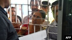A woman, whose name is left out in the National Register of Citizens (NRC) draft, stands in a a line to collect forms to file appeals at a NRC Sewa Kendra (NSK) in Guwahati, Aug. 11, 2018.