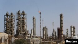 FILE - Pipelines are seen at the industrial zone at the oil port of Brega, Libya, Jan. 12, 2017. 