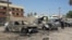 A man looks at damaged vehicles at the site of a car bomb attack in Baghdad's Kadhimiya district, September 30, 2013.