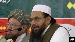 Hafiz Mohammad Saeed, right, chief of Jamaat-ud-Dawwa and founder of Lashkar-e-Taiba, addresses a news conference with anti-American cleric Sami ul Haq in Rawalpindi, Pakistan, April 4, 2012.