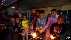 Children play with firecrackers on Diwali festival, the Hindu festival of lights, at an orphanage in Jammu, India, Oct.31, 2024. 