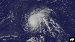 FILE - Satellite image released by the US National Oceanic and Atmospheric Administration, shows Hurricane Danny over the Atlantic Ocean, Aug. 21, 2015.