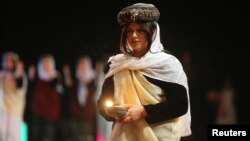 Yazidis traditional group performs during the commemoration of the third anniversary of what the United Nations said was a genocide, in Duhok, Iraq, Aug. 3, 2017.