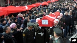 People carry the coffin after funeral prayers for Turkish soldier Goktan Ozupekin, who was killed with 15 others by IS militants in al-Bab, Syria, in Kirklareli , Turkey, Friday, Dec. 23, 2016.