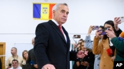 Calin Georgescu, an independent candidate for president who came first after the first round of presidential elections, casts his vote in the country's parliamentary elections, in Mogosoaia, Romania, Dec. 1, 2024.