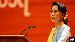 FILE - Myanmar's State Counsellor Aung San Suu Kyi speaks during the opening ceremony of the second session of the 21st Century Panglong Union Peace Conference at the Myanmar International Convention Centre in Naypyitaw, Myanmar, May 24, 2017. 