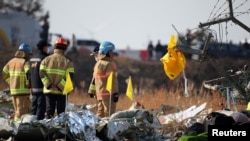 A life jacket hangs on fencing next to the wreckage of an aircraft that crashed after it went off the runway at Muan International Airport, in Muan, South Korea, Dec. 29, 2024.