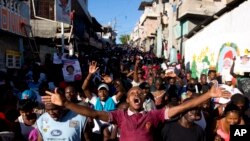 Supporters of presidential candidate Maryse Narcisse, from Fanmi Lavalas political party, chant victory slogans during a protest in Port-au-Prince, Haiti, Nov. 28, 2016.