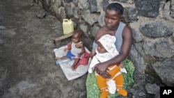 A woman looks after her two babies after being abandoned by her husband for being raped, in Goma. UNICEF estimates over 1,000 women and girls are raped per month in the Democratic Republic of Congo (File)