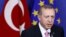 FILE - Turkey's President Tayyip Erdogan talks to the media at the EU Commission headquarters in Brussels, Belgium, Oct. 5, 2015. 