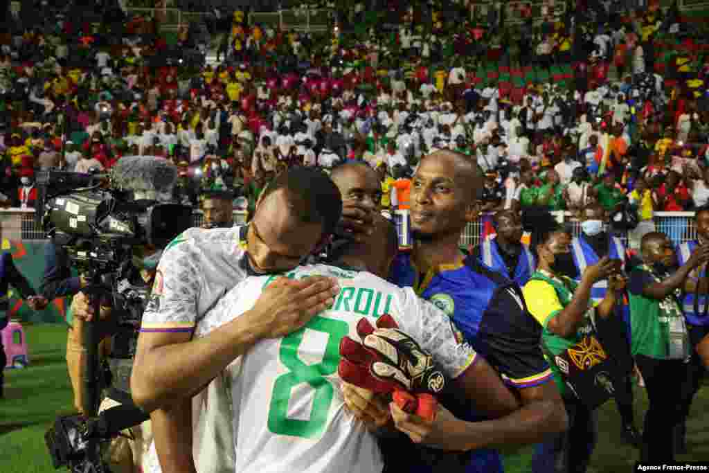 Comoros' midfielder Fouad Bachirou (C) is consoled by teammates after they lost the game against Cameroon, Jan. 24, 2022.