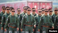 Members of Chinese People's Liberation Army (PLA) Air Force Red Falcon aerobatic team attend the China International Aviation and Aerospace Exhibition in Guangdong province, China, Sept. 28, 2021. 